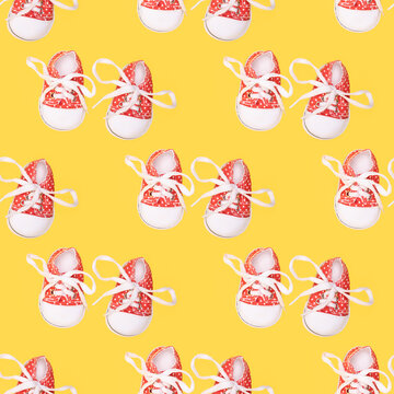 seamless pattern of children's red shoes on a yellow background