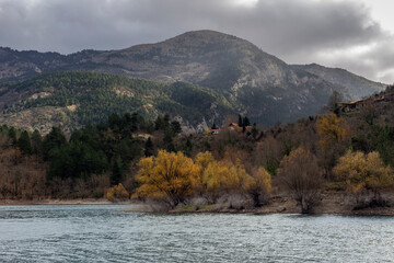 A view of the natural Lake Tsivlou (Peloponnese, Greece) and mountains around on a cloudy winter day