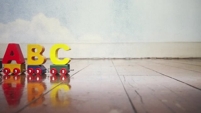 Toy train ABC on an old wooden floor  stop motion  loop 