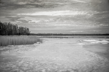 Frozen Lake in February in Latvia with Cloudscape