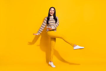 Fototapeta na wymiar Full size photo of young beautiful happy excited crazy cheerful smiling girl dancing isolated on yellow color background