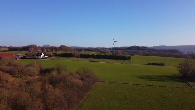 Pasture land and wind turbine on a sunny day at Warstein, Germany - aerial view