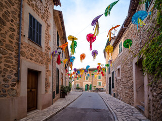 houses in the city of Deia at times of celebration are decorated in the streets with colorful art...