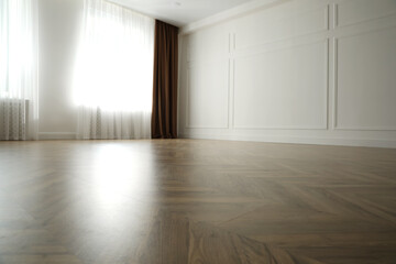 Parquet floor in light spacious empty room