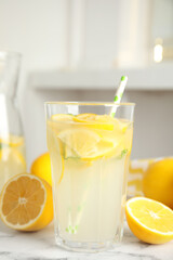 Cool freshly made lemonade and fruits on white marble table