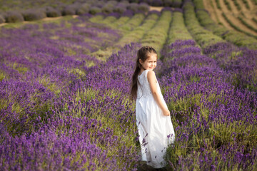 Cute little girl having fun in a lavender field