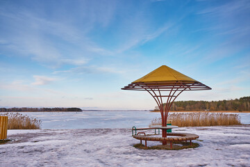 Early Spring With Melting Ice And Snow. Frozen beach. Place for rest in lower season.