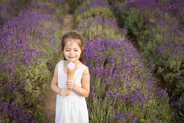 Cute little girl having fun in a lavender field