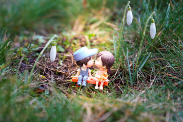 Miniature Love Couple With Light Beam Between Snow Drops