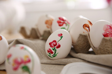 Beautifully painted Easter eggs on table indoors