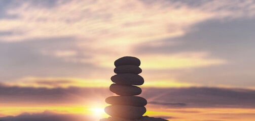 Balanced Pebbles Pyramid on the Beach on Sunny Day.