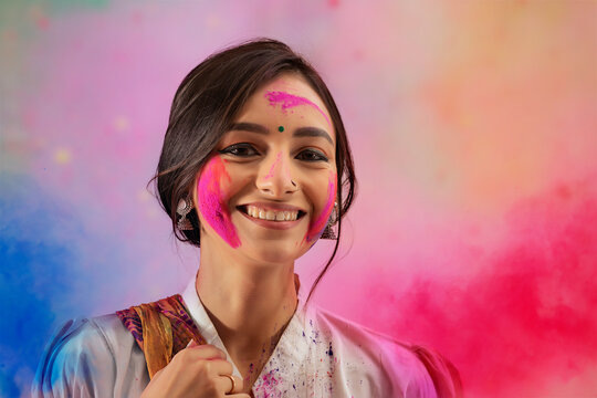 A HAPPY YOUNG WOMAN LOOKING AT CAMERA WITH COLOURS ALL AROUND	