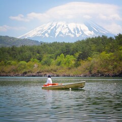 Japan landscapes in spring. Fuji-Hakone-Izu National Park. Mount Fuji (Volcano Fuji). Fishing boat on a lake.