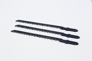 Three saw blades for a jigsaw.