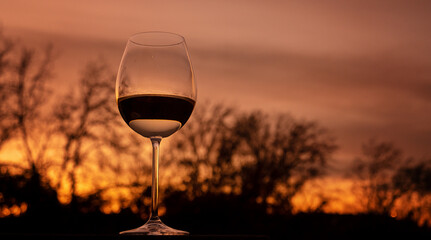 glass of red wine at sunset 