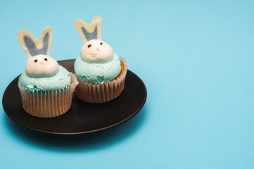 Easter cupcakes on a plate on blue background