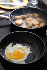preparing fried eggs in a frying pan