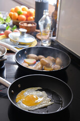 preparing fried eggs in a frying pan