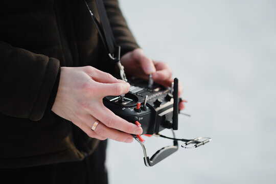 holds in hand a remote control from a fpv drone or a car