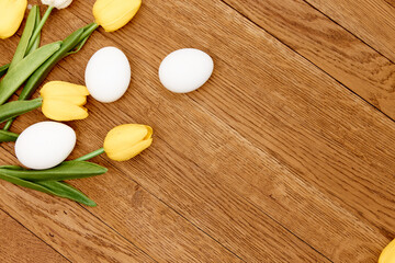Fototapeta na wymiar tulip bouquet white eggs decoration wooden background holiday