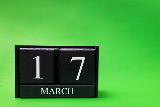 Block calendar for March 17 St Patrick's Day on green background