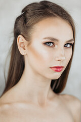 Naklejka premium Portrait of a beautiful model with a mysterious look, beauty fashion portrait of a young girl, isolated light background