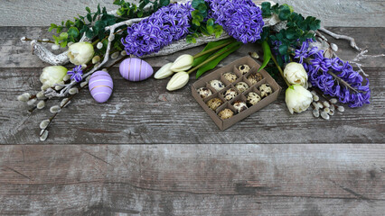 Easter background: quail eggs with tulips and hyacinths