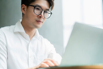 Smart attractive positive asian business male wearing glasses work remote new normal lifestyle hand...