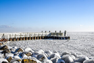 Ice accretion on one of the jetties of the Afsluitdijk, Netherlands. © Bert