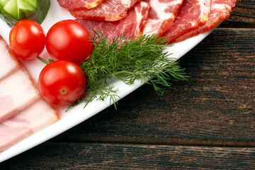 Cherry tomatoes with dill and ham on a plate. Copy space