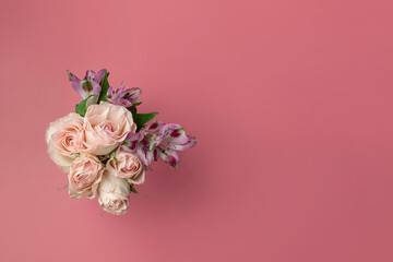 a bouquet of beautiful flowers on a pink background copy the space. the concept of spring, holiday and beauty