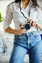 Urban fashion young girl holding retro film camera.