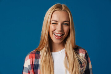 Happy beautiful blonde girl smiling and winking at camera