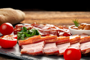 Assorted sliced brisket on slate with copy space.