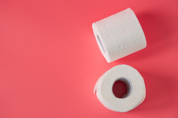 Toilet paper on pink background