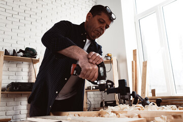 Close up of a carpenter drilling a hole in timber