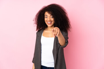 Young african american woman over isolated background surprised and pointing front