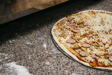 Pizza before baking in the oven. Raw pizza