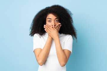 Young african american woman over isolated background covering mouth with hands