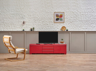Television unit on the red cabinet in the room, rocking chair, poster and frame, white brick wall concept and under brown classic detail background.
