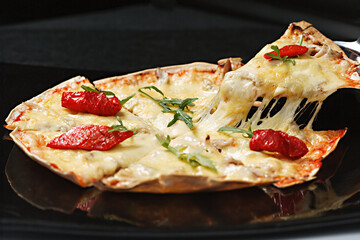 Italian pizza Tortilla with grated Mozzarella