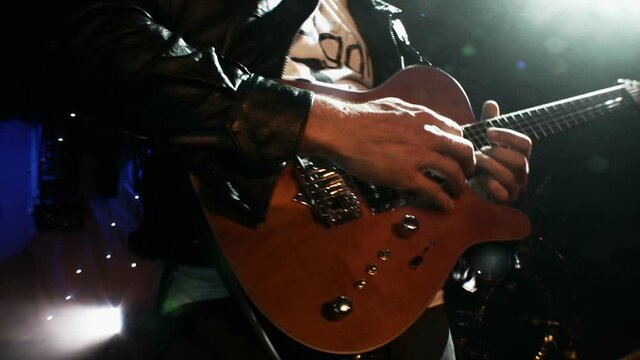 Rock Guitarist playing guitar at a live concert