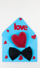 Happy valentine's day concept. Flat lay top view photo of blue open envelope with paper card in shape of heart with mock up space on white background