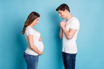 Profile photo of nice young family look stomach good mood cant wait child isolated on blue color background