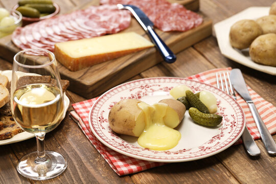 melting raclette cheese with freshly boiled potatoes, swiss food