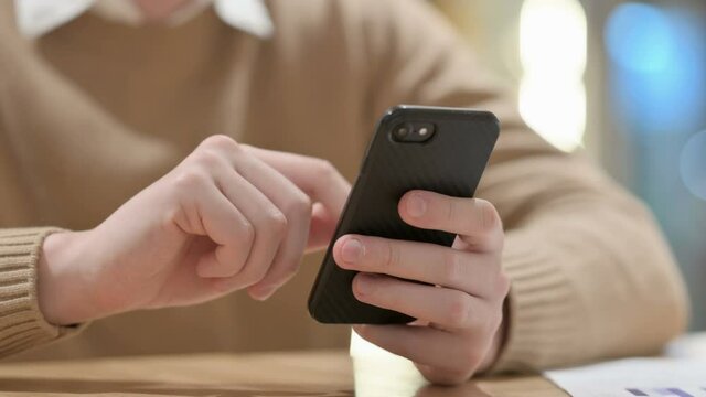 Close up of Hands of Young Man Using Smartphone 
