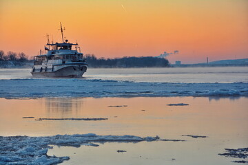 the ship sails on the river in winter