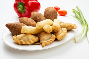 Lebanese Plate of Kebbeh , cheese rolls meat pie isolated on white.