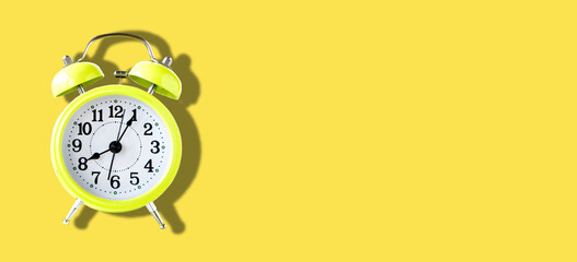 Yellow Alarm Clock on Yellow Background in Banner size
