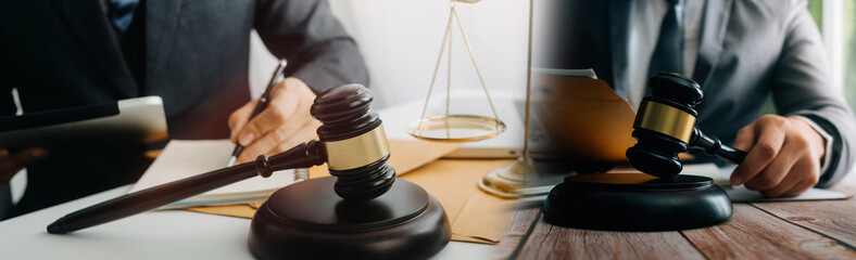 Business and lawyers discussing contract papers with brass scale on desk in office. Law, legal services, advice, justice and law concept